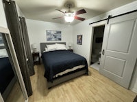 a bedroom with a bed and a ceiling fan