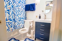 a bathroom with a blue and white shower curtain